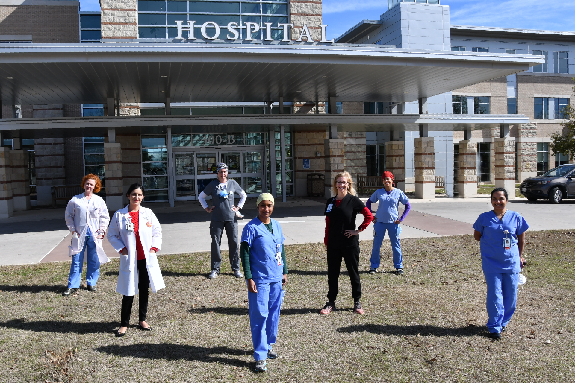 Women physicians in front of a hospital entrance